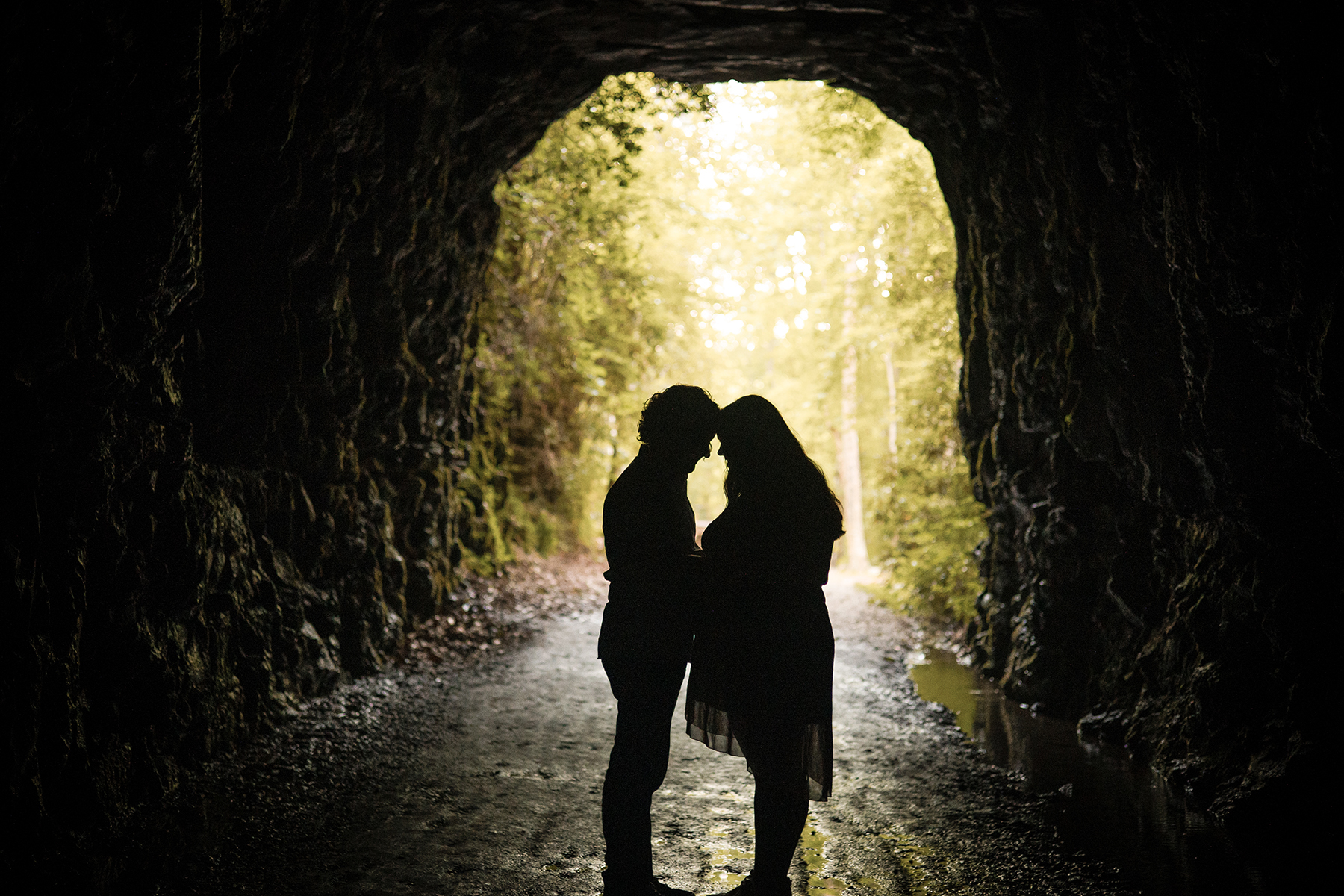 engaged couple standing in Stumphouse Tunnel photoshoot